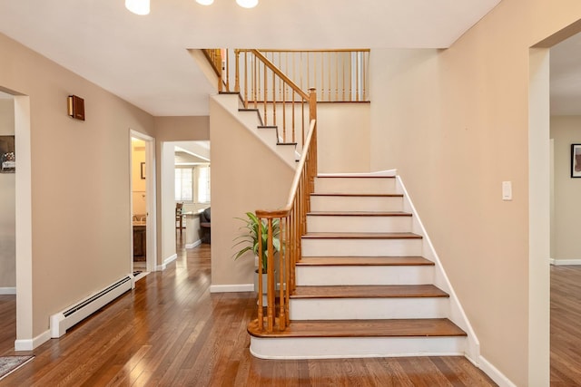 10 Northwood Ct, Dix Hills, NY 11746 - stairway with a baseboard radiator, hardwood / wood-style flooring, and baseboards