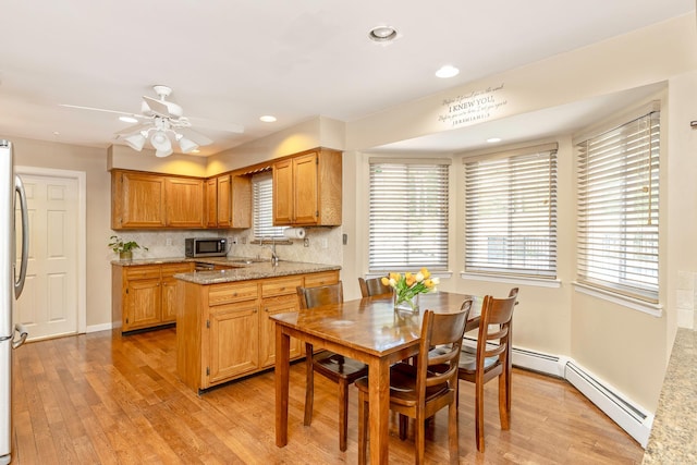 10 Northwood Ct, Dix Hills, NY 11746 - kitchen featuring appliances with stainless steel finishes, light wood-style flooring, a sink, recessed lighting, and decorative backsplash