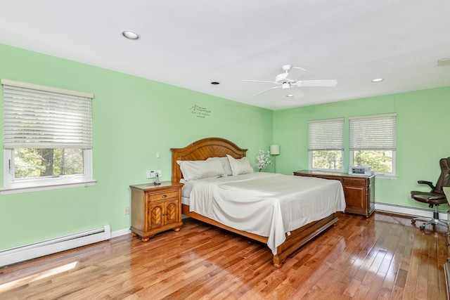 10 Northwood Ct, Dix Hills, NY 11746 - bedroom with multiple windows, a baseboard heating unit, wood finished floors, and recessed lighting