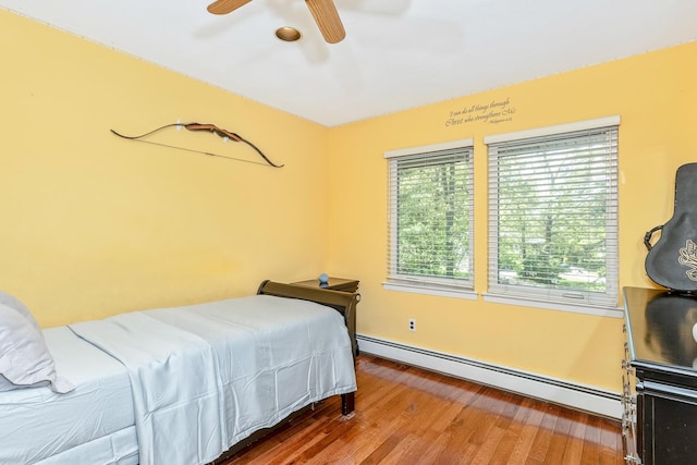 10 Northwood Ct, Dix Hills, NY 11746 - bedroom with a baseboard heating unit, wood finished floors, ceiling fan, and baseboards