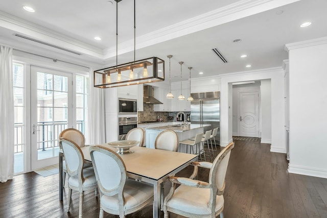 dining room featuring dark wood-style flooring, baseboards, crown molding, and recessed lighting
