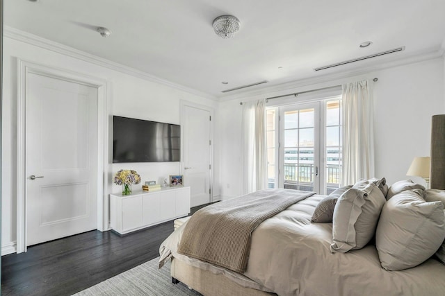 bedroom featuring crown molding, dark wood finished floors, and access to exterior