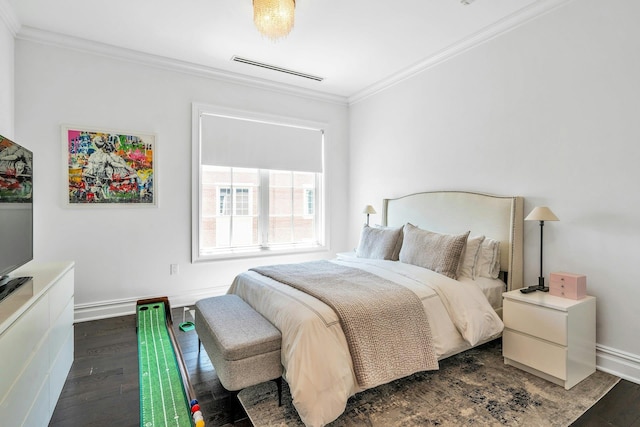 bedroom with crown molding, dark wood-type flooring, and baseboards