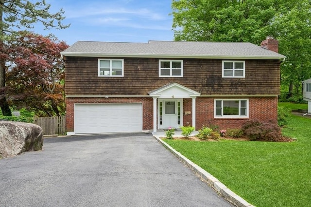 12 Glenn Pl, Hastings-On-Hudson, NY 10706 - view of front of property featuring an attached garage, a chimney, asphalt driveway, and brick siding