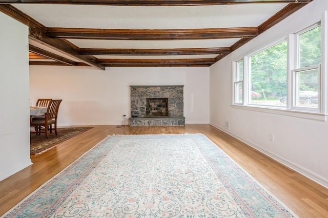 12 Glenn Pl, Hastings-On-Hudson, NY 10706 - living room with light wood-type flooring, beamed ceiling, baseboards, and a premium fireplace