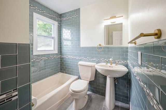 12 Glenn Pl, Hastings-On-Hudson, NY 10706 - bathroom with tile walls, a tub, toilet, tile patterned flooring, and wainscoting