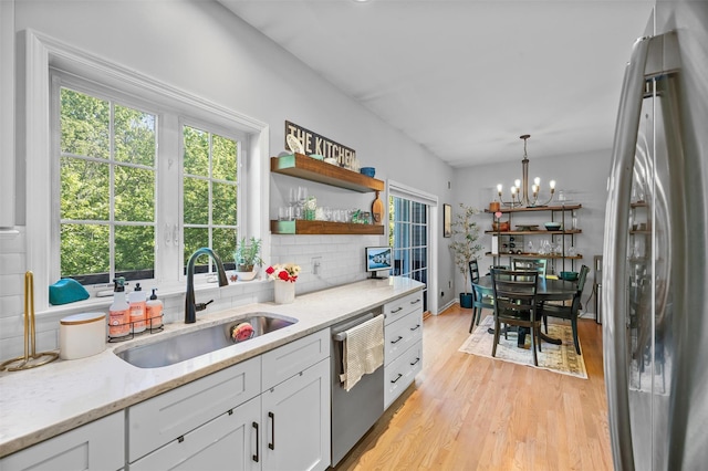 40 Peter Turner Rd, Monroe, NY 10950 - kitchen with stainless steel appliances, a sink, decorative backsplash, open shelves, and white cabinets