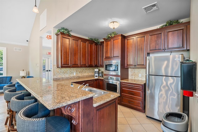 40 Peter Turner Rd, Monroe, NY 10950 - kitchen with appliances with stainless steel finishes, a sink, a peninsula, tasteful backsplash, and vaulted ceiling