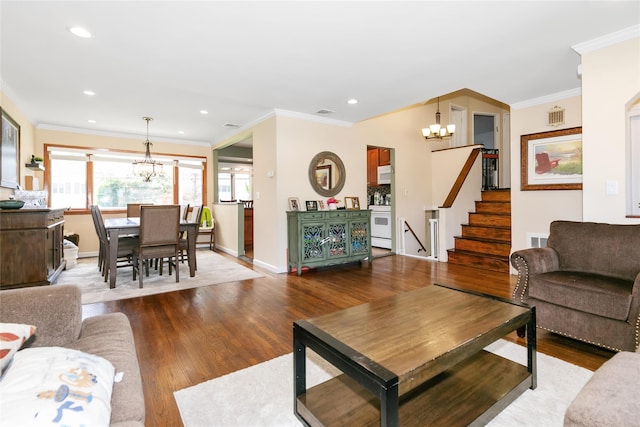 living room with a chandelier, wood finished floors, stairs, ornamental molding, and baseboards