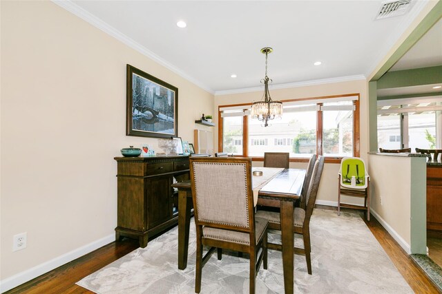 dining space with wood finished floors, a chandelier, baseboards, ornamental molding, and recessed lighting
