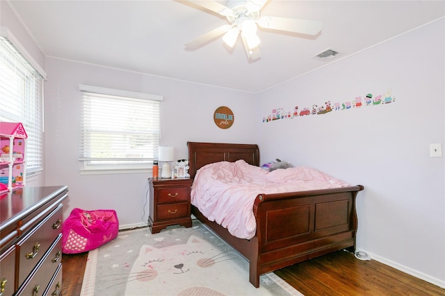 bedroom with baseboards, wood finished floors, and a ceiling fan