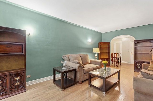 117-01 Park Ln S Unit C 1F, Kew Gardens, NY 11418 - living room with arched walkways, light wood finished floors, and baseboards