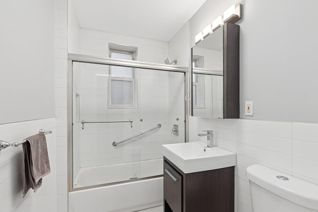 117-01 Park Ln S Unit C 1F, Kew Gardens, NY 11418 - bathroom featuring tile walls, vanity, toilet, and bath / shower combo with glass door