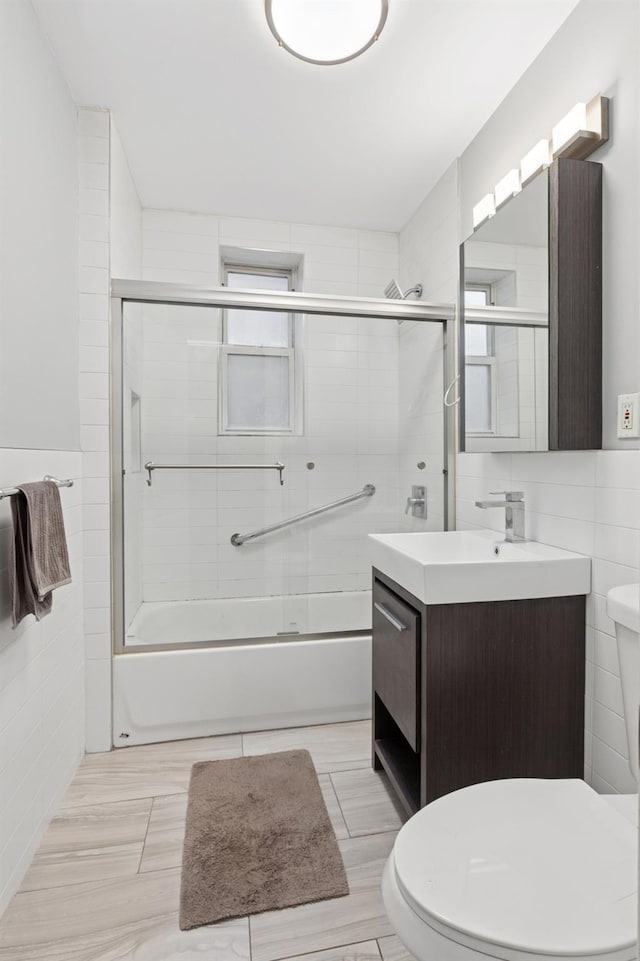 117-01 Park Ln S Unit C 1F, Kew Gardens, NY 11418 - full bathroom featuring toilet, tile walls, vanity, and enclosed tub / shower combo