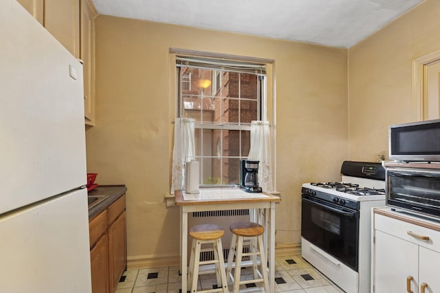 117-01 Park Ln S Unit C 1F, Kew Gardens, NY 11418 - kitchen featuring white appliances and baseboards