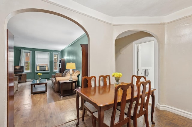 117-01 Park Ln S Unit C 1F, Kew Gardens, NY 11418 - dining room featuring arched walkways, light wood-style flooring, and baseboards