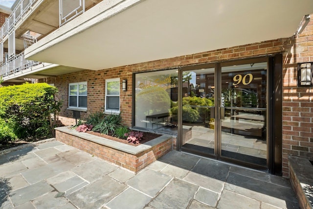 view of exterior entry with brick siding