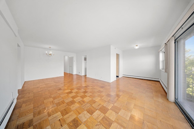 spare room featuring baseboard heating, a chandelier, and healthy amount of natural light