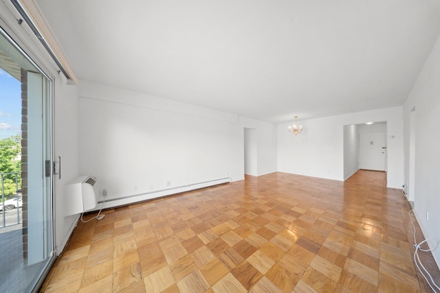 unfurnished room with a chandelier and a baseboard heating unit