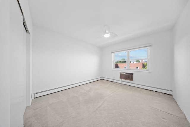 carpeted spare room with a baseboard heating unit and an AC wall unit