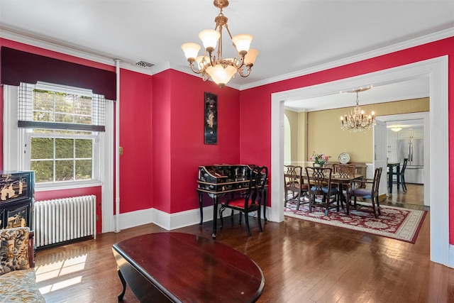 70 Willow Ln, New Windsor, NY 12553 - dining space featuring radiator, a chandelier, hardwood / wood-style flooring, baseboards, and ornamental molding