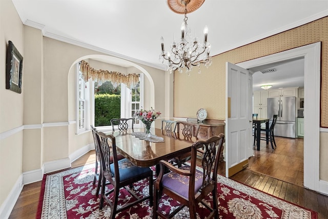 70 Willow Ln, New Windsor, NY 12553 - dining area featuring ornamental molding, wood-type flooring, arched walkways, a chandelier, and baseboards