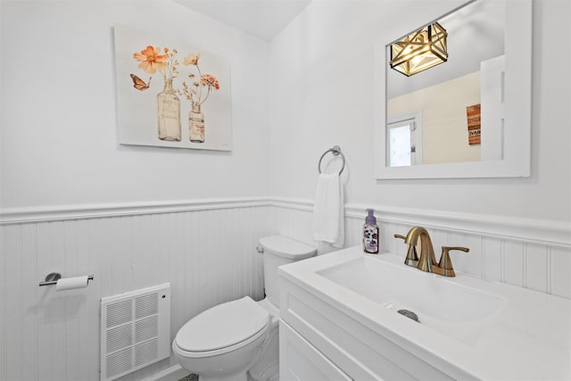70 Willow Ln, New Windsor, NY 12553 - half bathroom featuring a wainscoted wall, toilet, and vanity