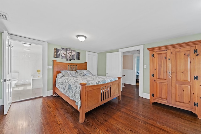 70 Willow Ln, New Windsor, NY 12553 - bedroom featuring dark wood finished floors, baseboards, and ensuite bathroom