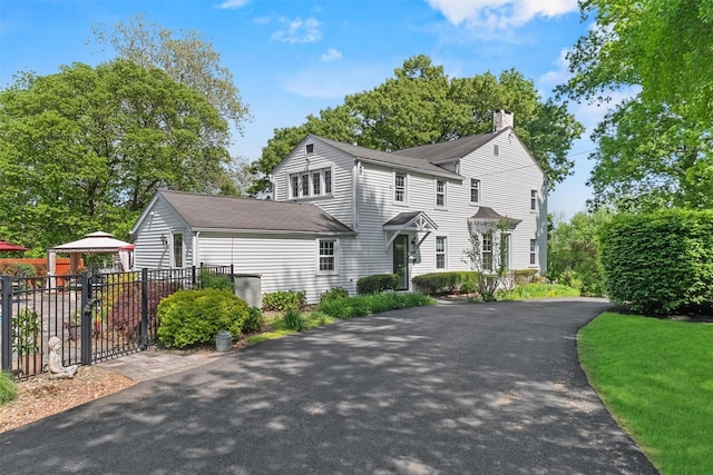 70 Willow Ln, New Windsor, NY 12553 - view of front of house with a chimney, fence, a shingled roof, a gazebo, and driveway