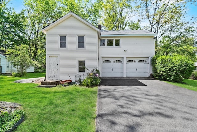 70 Willow Ln, New Windsor, NY 12553 - view of front of home with an attached garage, asphalt driveway, a front lawn, and a chimney