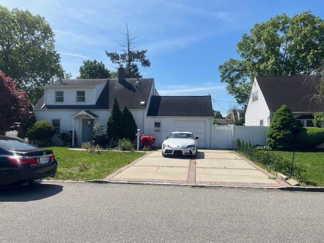 664 Bryant St, Westbury, NY 11590 - view of front of property featuring concrete driveway, a chimney, and a garage