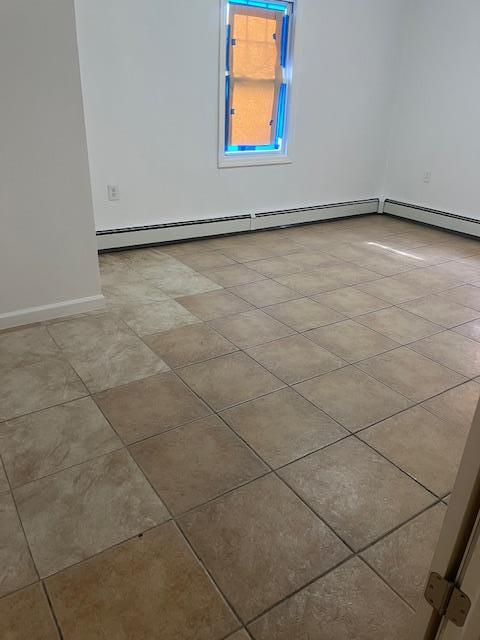 664 Bryant St, Westbury, NY 11590 - spare room with baseboards and light tile patterned floors