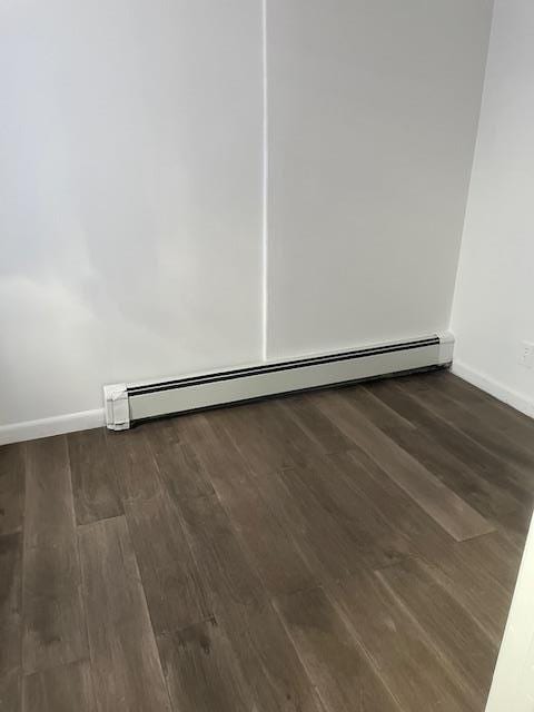 664 Bryant St, Westbury, NY 11590 - empty room featuring wood finished floors and baseboards