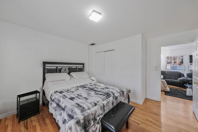 69 Plum St, Central Islip, NY 11722 - bedroom featuring light wood-style floors, baseboards, and a closet