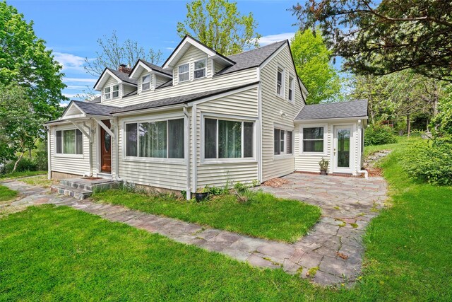 180-184 Pine Tree Rd, Monroe, NY 10950 - view of front of home featuring a patio, a front lawn, a chimney, and roof with shingles