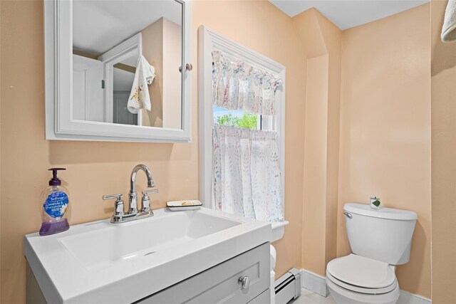 180-184 Pine Tree Rd, Monroe, NY 10950 - bathroom featuring toilet, a baseboard heating unit, vanity, and baseboards