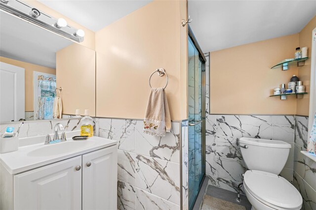180-184 Pine Tree Rd, Monroe, NY 10950 - full bathroom featuring tile walls, a stall shower, vanity, a wainscoted wall, and toilet