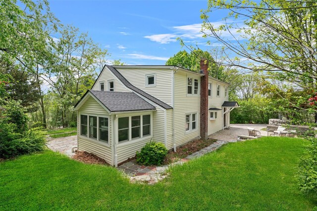 180-184 Pine Tree Rd, Monroe, NY 10950 - rear view of property with a patio, a shingled roof, a chimney, and a lawn