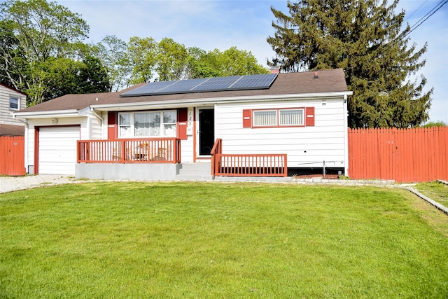 125 Timberline Dr, Brentwood, NY 11717 - ranch-style house with a garage, roof mounted solar panels, gravel driveway, and a porch