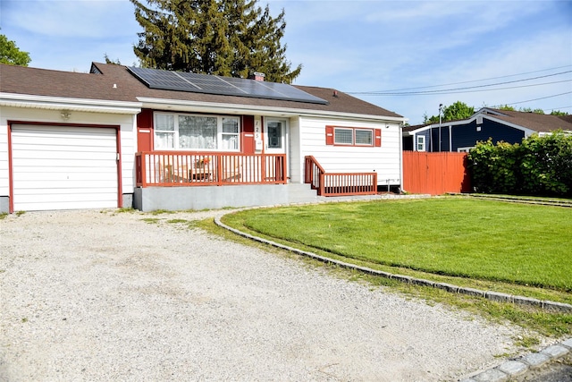125 Timberline Dr, Brentwood, NY 11717 - ranch-style home featuring solar panels, covered porch, an attached garage, and driveway