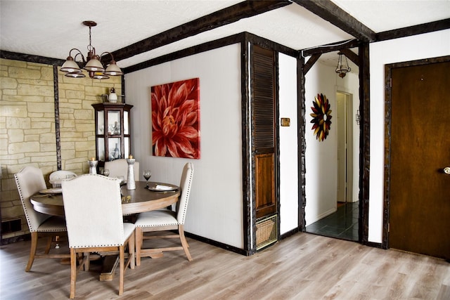 125 Timberline Dr, Brentwood, NY 11717 - dining room with beamed ceiling, light wood-style floors, a chandelier, baseboards, and a textured ceiling