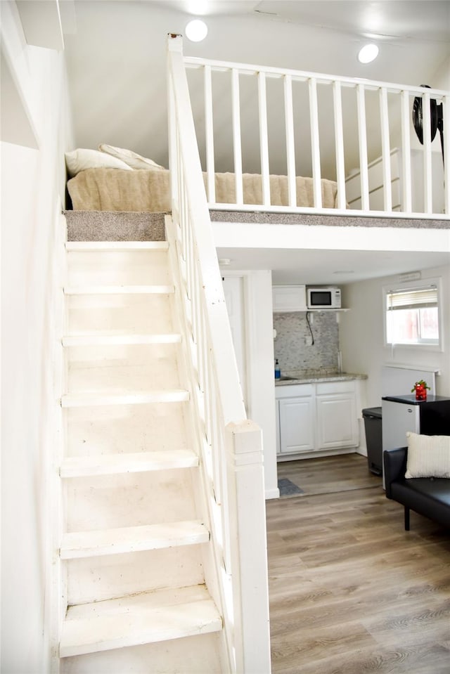 125 Timberline Dr, Brentwood, NY 11717 - stairs with wood finished floors