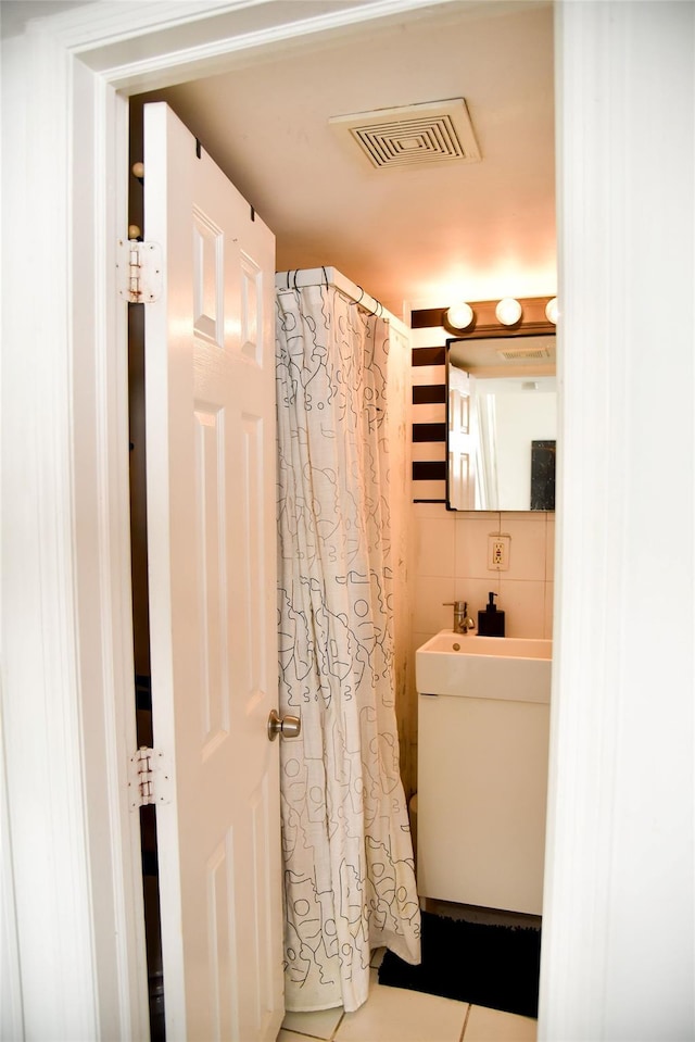 125 Timberline Dr, Brentwood, NY 11717 - bathroom with tile walls, tile patterned flooring, and curtained shower