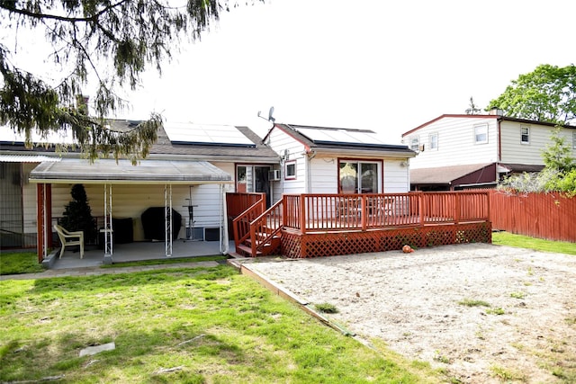 125 Timberline Dr, Brentwood, NY 11717 - rear view of house with a patio area, solar panels, and a deck