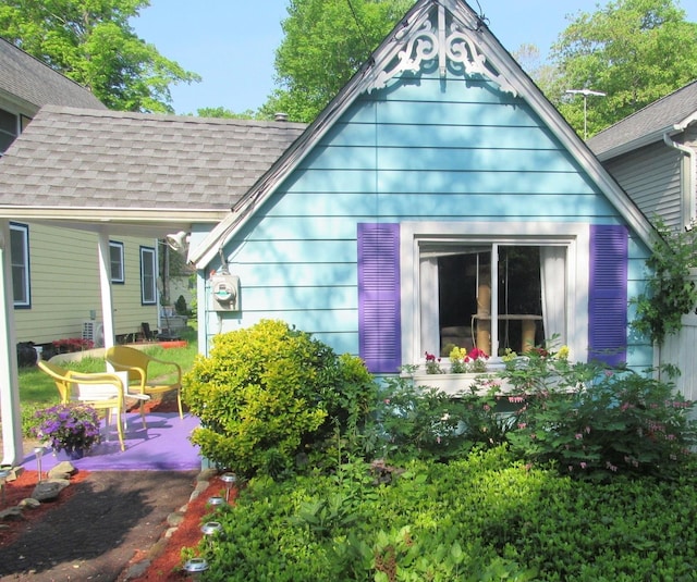 42 Campwoods Rd, Ossining, NY 10562 - view of home's exterior featuring roof with shingles and a patio area