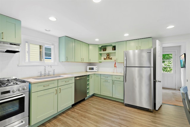 42 Campwoods Rd, Ossining, NY 10562 - kitchen featuring stainless steel appliances, green cabinets, a sink, under cabinet range hood, and open shelves