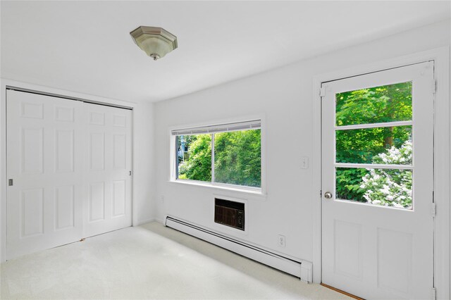 42 Campwoods Rd, Ossining, NY 10562 - unfurnished bedroom featuring a baseboard radiator, carpet flooring, a closet, and a wall unit AC