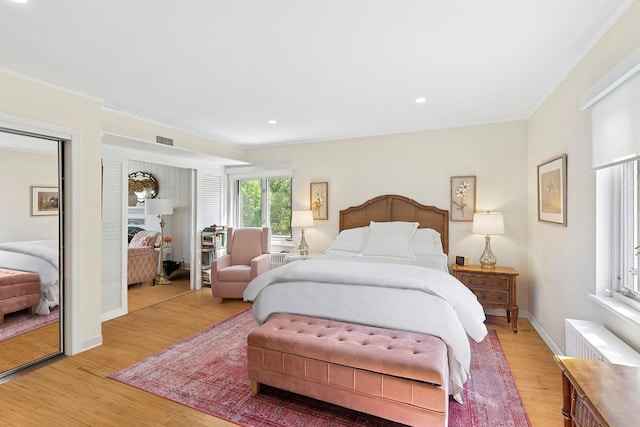 47 Rampasture Rd Apt M, Hampton Bays, NY 11946 - bedroom featuring light wood-style flooring, two closets, baseboards, ornamental molding, and recessed lighting