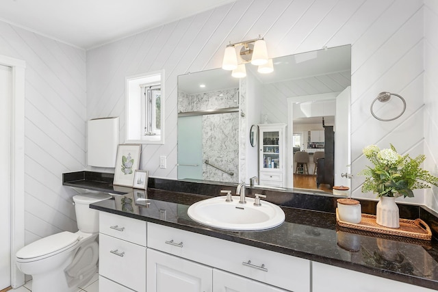 47 Rampasture Rd Apt M, Hampton Bays, NY 11946 - bathroom with a shower stall, toilet, wood walls, and vanity