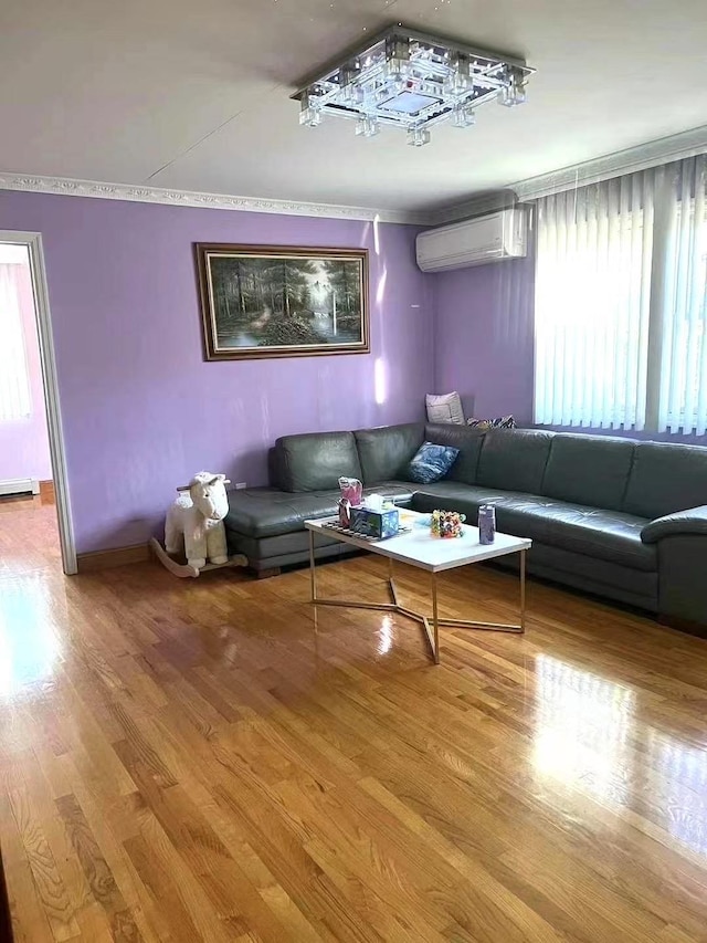214-27 38th Ave, Bayside, NY 11361 - living room featuring an AC wall unit, wood finished floors, ornamental molding, and baseboards